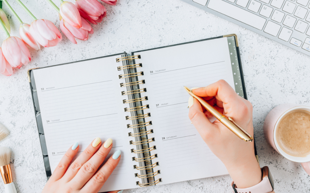 Woman writing down to-do tasks on her daily planner
